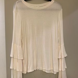 white long sleeve top with ruffle sleeves